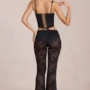 Calista Sheer Lace Mid-Rise Flared Trousers in Schwarz Calista Sheer Lace Mid-Rise Flared Trousers in Schwarz